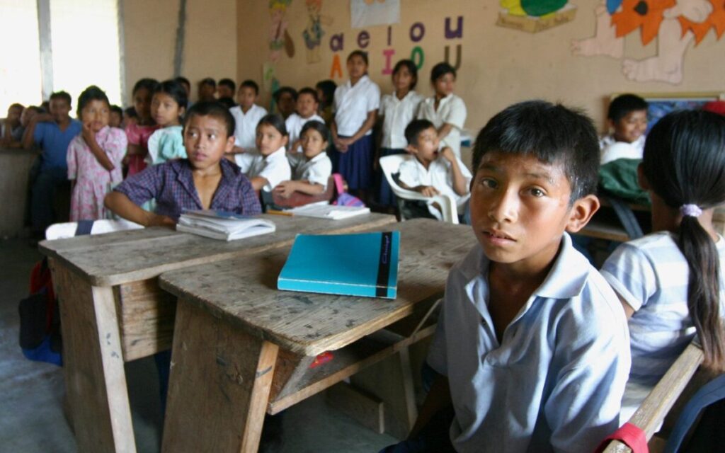 Grupo de jóvenes mexicanos en un aula modesta que refleja el impacto del rezago educativo y la falta de oportunidades laborales
