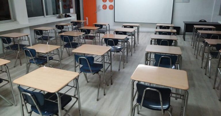 Estudiantes mexicanos trabajando en un aula moderna que refleja avances hacia educación de calidad y equidad.